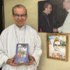 Cardinal Gregorio Rosa Chávez holding a copy of his book on Oscar Romero.